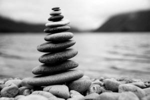 Zen Balancing Pebbles Next to a Misty Lake The Ohana Hawaii