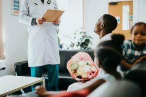 Doctor giving good news to relatives in the waiting room