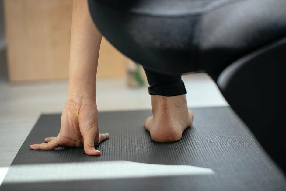 a person performing yoga on a mat