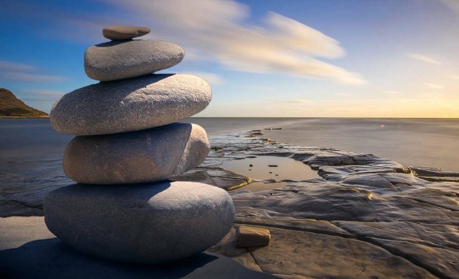 Rocks stacked in a meditation style overlooking the ocean in hawaii