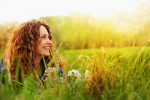 A woman smiling in the beautiful fields of hawaii