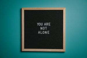 a sign reading you are not alone