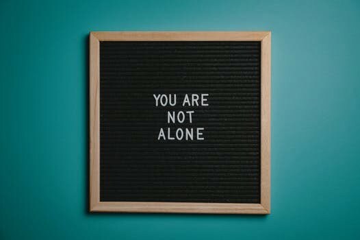 a sign reading you are not alone