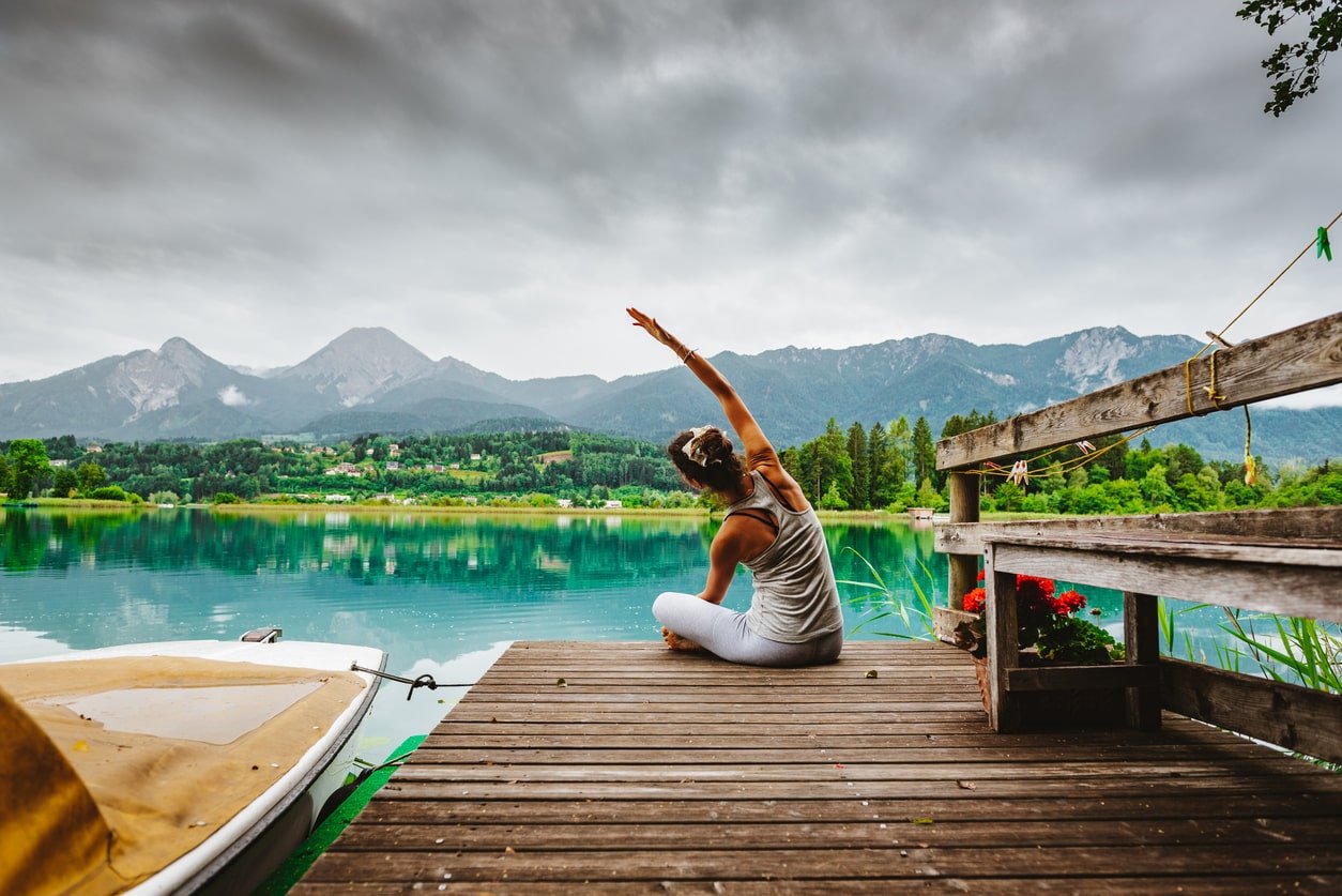 Woman Stretching by lake