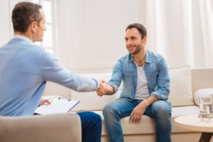 A man shaking hands with his therapist